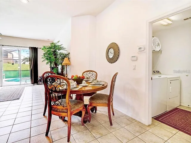 a dining room with furniture and window