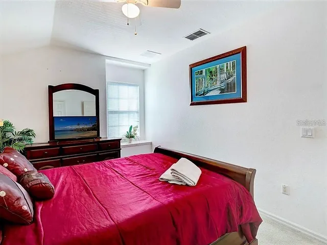a bedroom with two beds and a chandelier