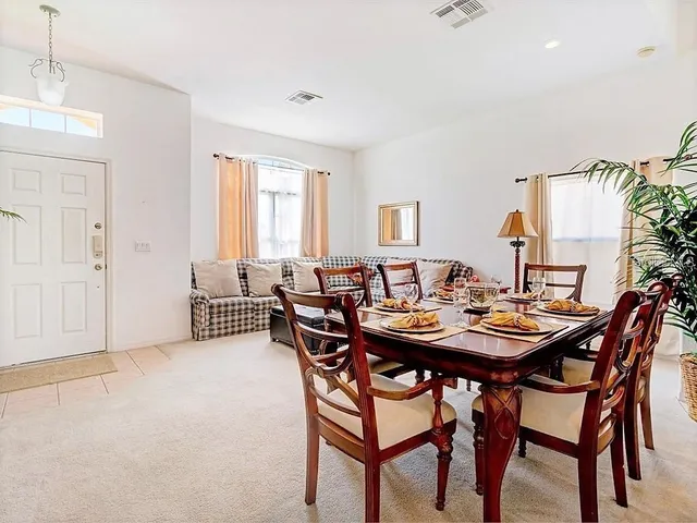 a view of a dining room with furniture and window