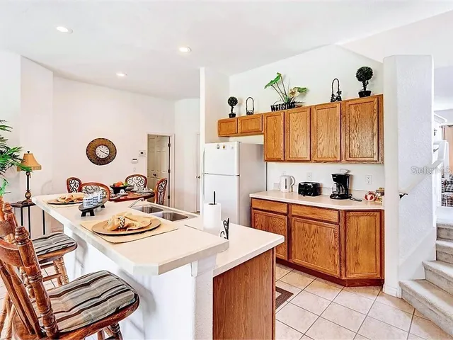a kitchen with a table chairs stove and cabinets