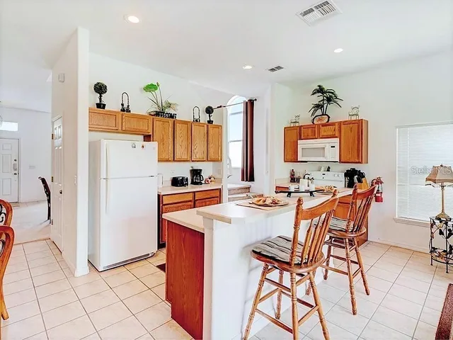 a view of a kitchen with a dining table and chairs