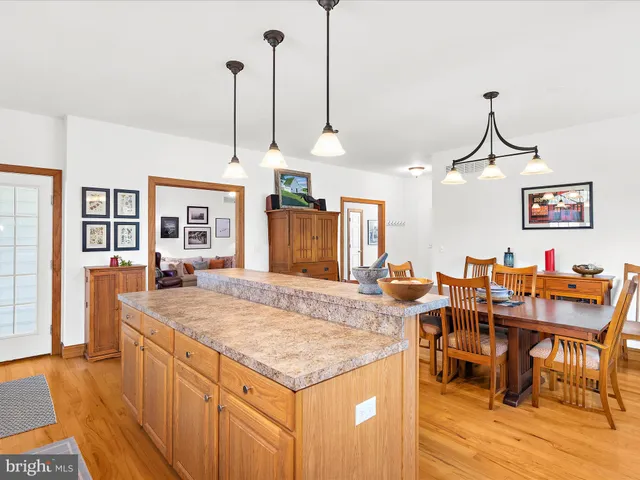 a living room with dining table and wooden floor