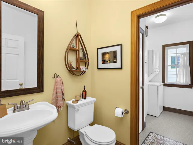 a bathroom with a toilet a sink and a mirror