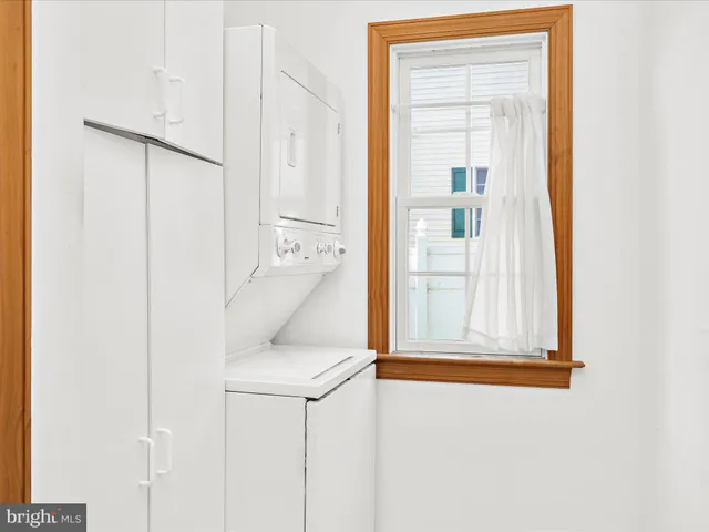 a white cabinet sitting next to a window