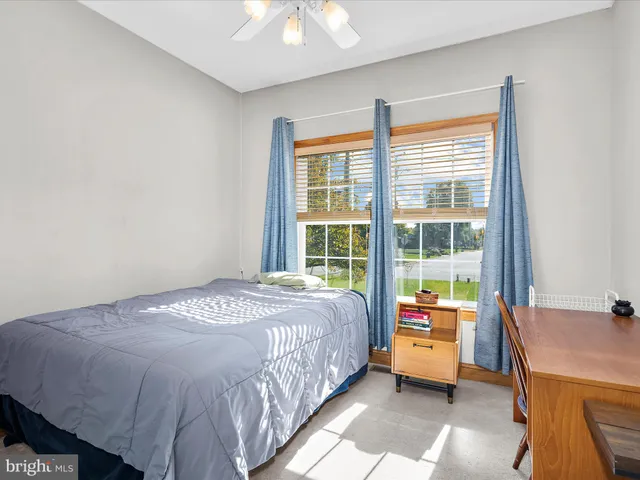 a bed sitting in a bedroom next to a window
