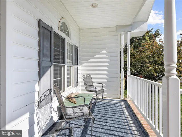 a view of balcony with wooden floor and outdoor seating