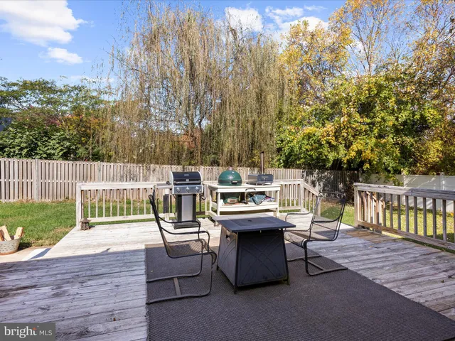 a view of a deck with furniture and garden