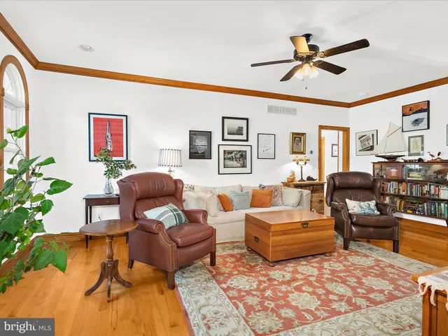 a living room with furniture wooden floor and a window