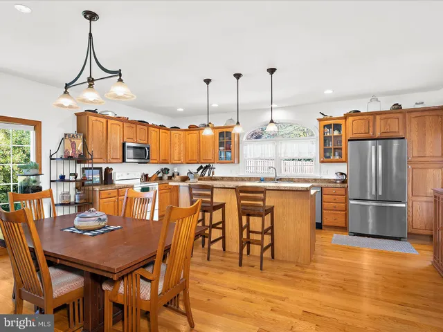 a dining table chairs and a living room with kitchen view