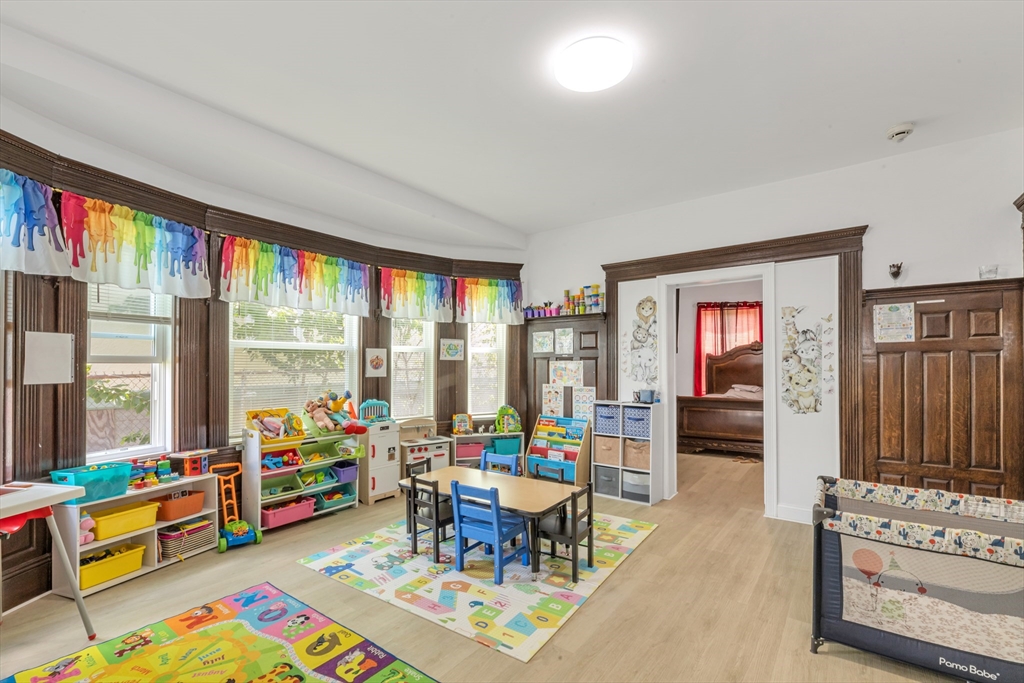 36 Brookledge Street Boston, MA 02121 - Photo 7 of 31 a play room with furniture and a floor to ceiling window