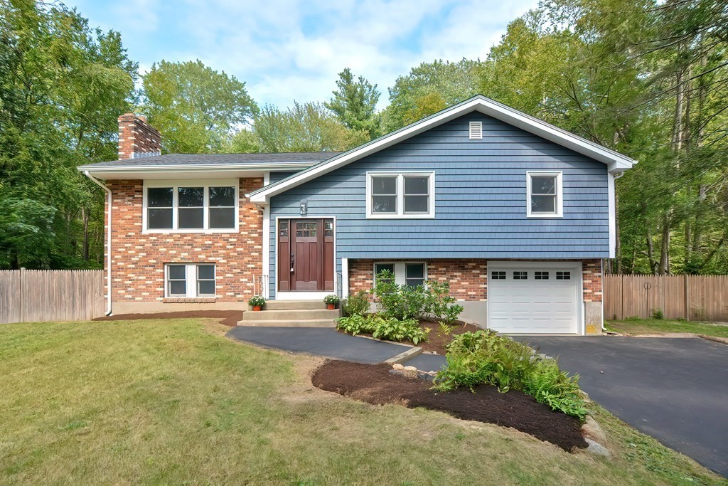 a front view of a house with a garden and plants
