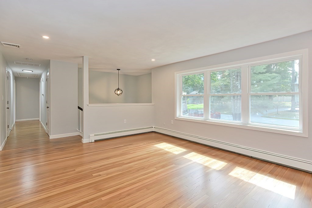 31 Clarkson Drive Walpole, MA 02081 - Photo 11 of 36 a view of an empty room with wooden floor and a window