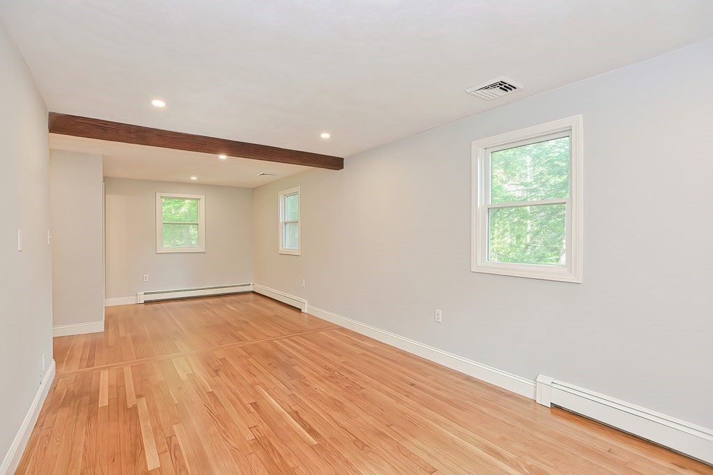 31 Clarkson Drive Walpole, MA 02081 - Photo 15 of 36 an empty room with wooden floor and windows