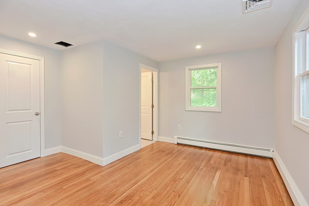 31 Clarkson Drive Walpole, MA 02081 - Photo 16 of 36 an empty room with wooden floor and windows