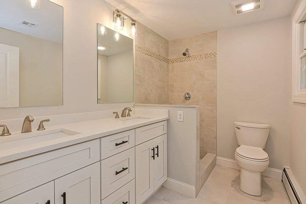 31 Clarkson Drive Walpole, MA 02081 - Photo 17 of 36 a spacious bathroom with a toilet sink and mirror