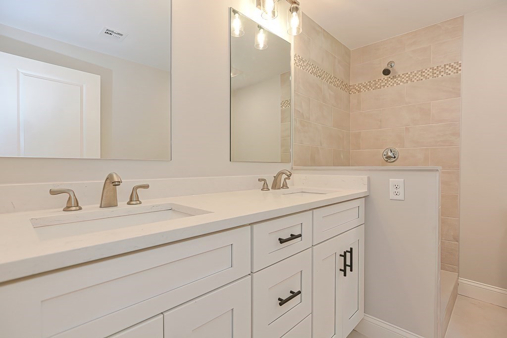 31 Clarkson Drive Walpole, MA 02081 - Photo 19 of 36 a bathroom with double sink and a mirror