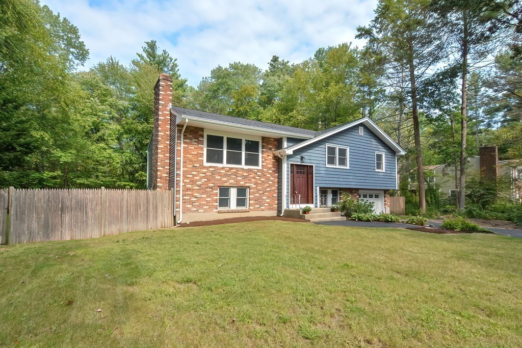 31 Clarkson Drive Walpole, MA 02081 - Photo 2 of 36 a front view of a house with a garden and trees