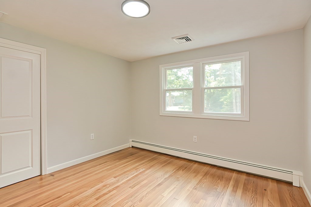 31 Clarkson Drive Walpole, MA 02081 - Photo 21 of 36 wooden floor in an empty room with a window