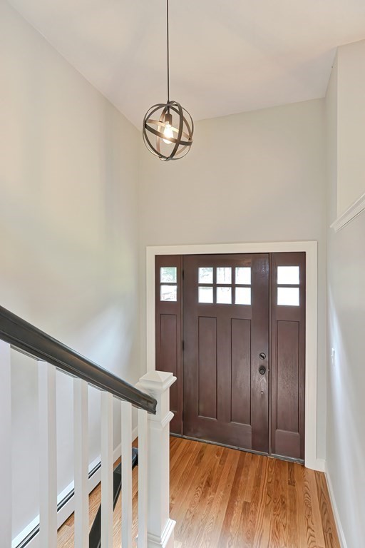 31 Clarkson Drive Walpole, MA 02081 - Photo 22 of 36 a view of a hallway with wooden floor and staircase