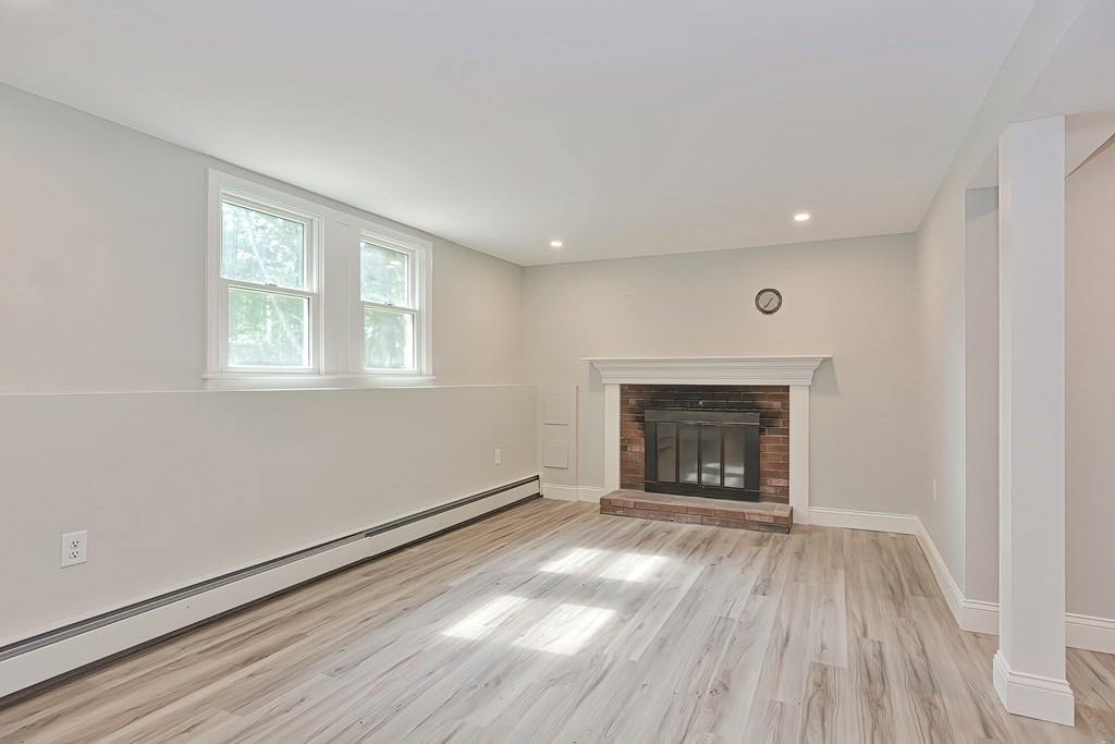 31 Clarkson Drive Walpole, MA 02081 - Photo 24 of 36 an empty room with wooden floor fireplace and windows