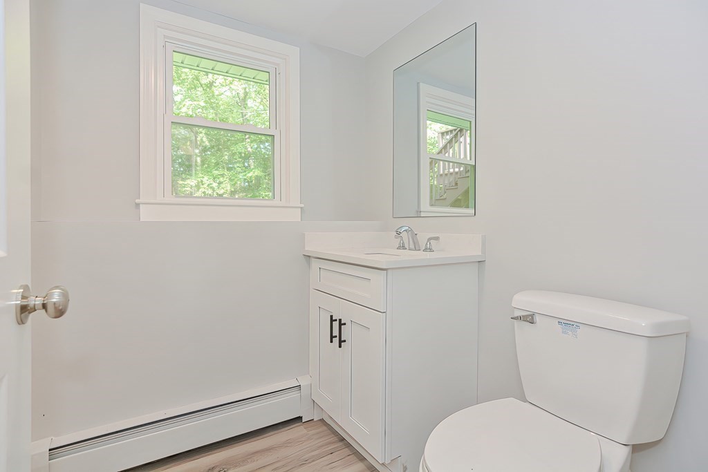 31 Clarkson Drive Walpole, MA 02081 - Photo 27 of 36 a bathroom with a toilet sink and mirror