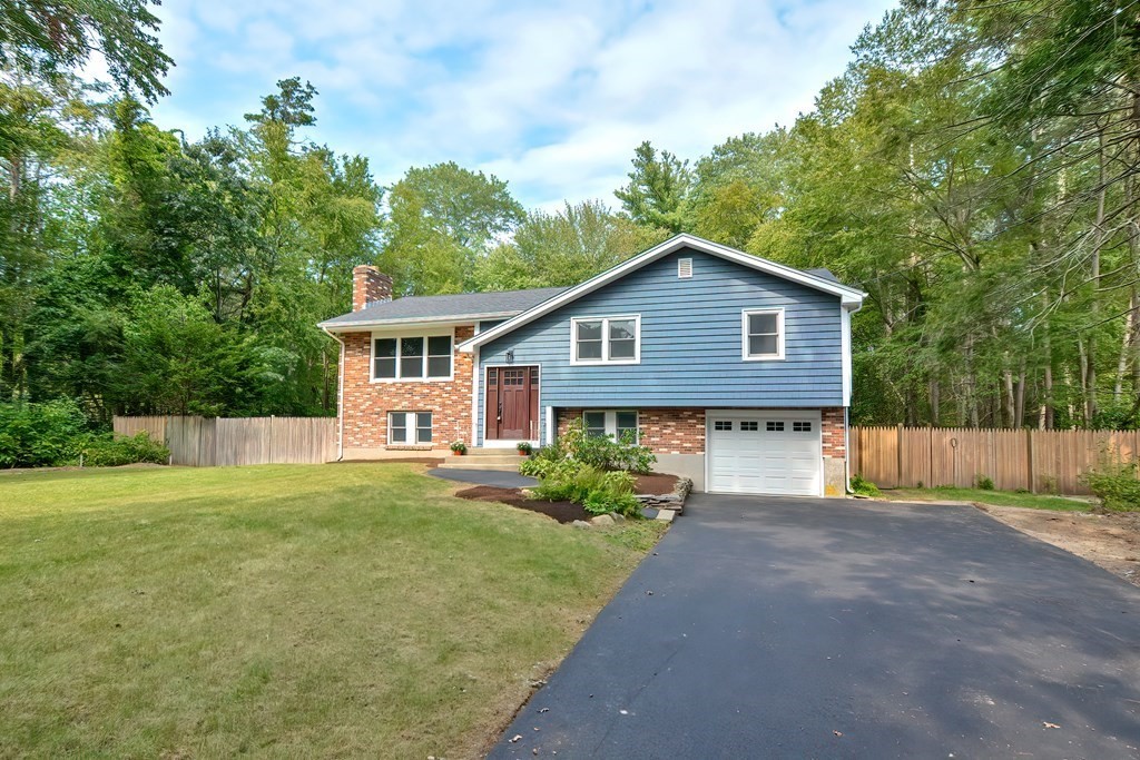 31 Clarkson Drive Walpole, MA 02081 - Photo 34 of 36 a front view of a house with a yard and trees