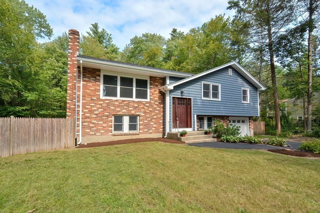 31 Clarkson Drive Walpole, MA 02081 - Photo 35 of 36 a front view of a house with a garden