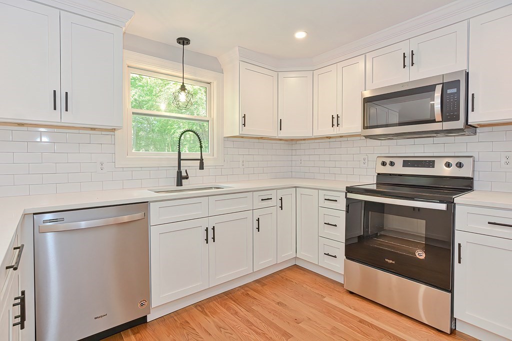 31 Clarkson Drive Walpole, MA 02081 - Photo 5 of 36 a kitchen with white cabinets appliances and a sink