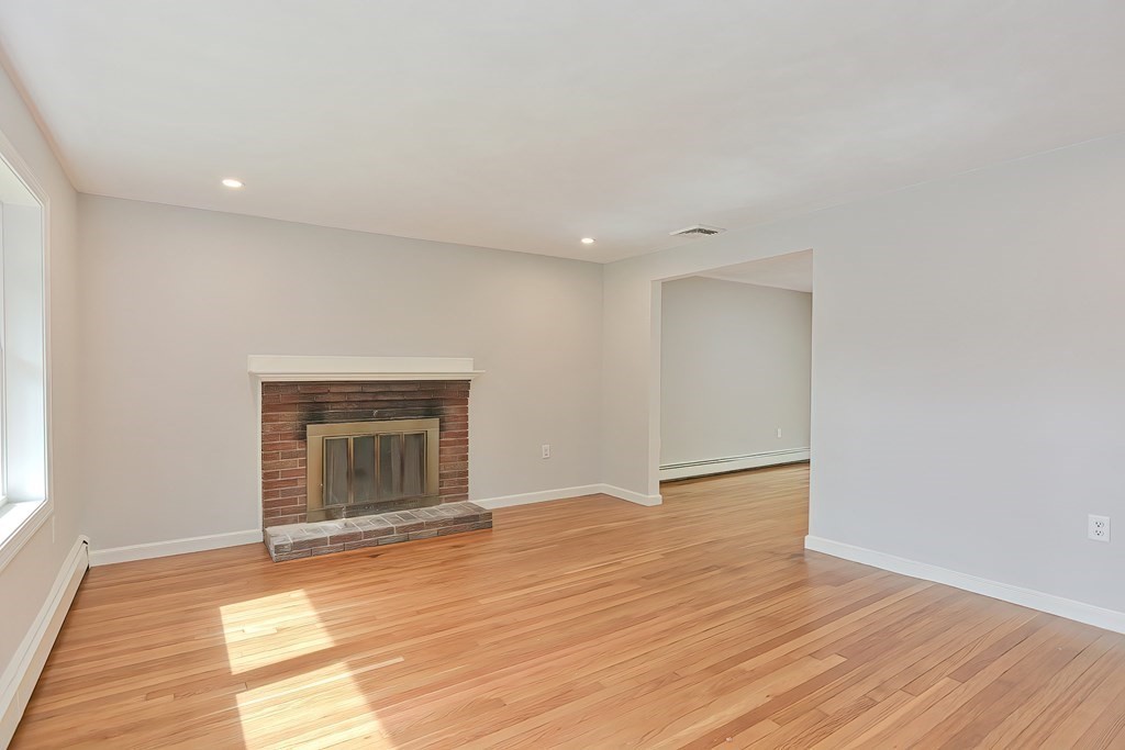 31 Clarkson Drive Walpole, MA 02081 - Photo 10 of 36 a view of empty room with wooden floor and fan