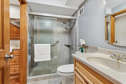 a bathroom with a sink toilet and shower