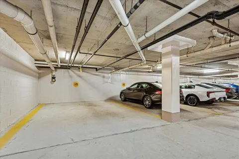 a view of parking garage with cars parked