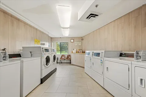 a kitchen with cabinets and washer dryer