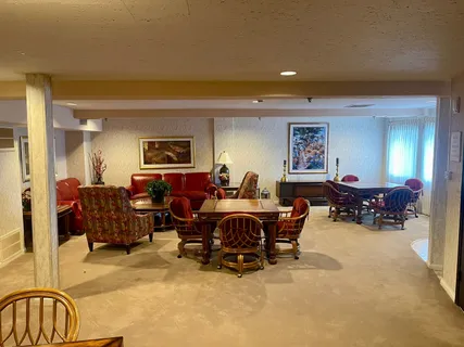 a living room with furniture and a gym machine