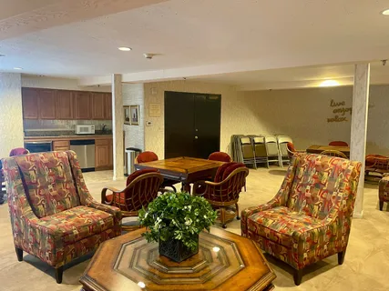 a living room with furniture and a lamp