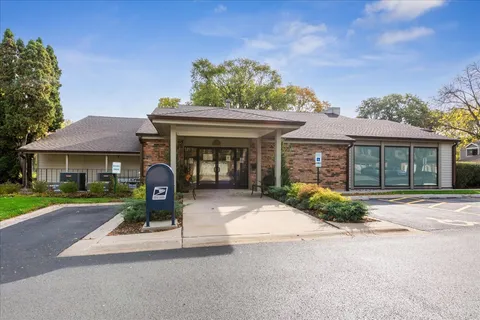 a front view of a house with garden and porch