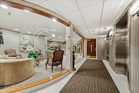 a view of a living room and bathroom with a bathtub