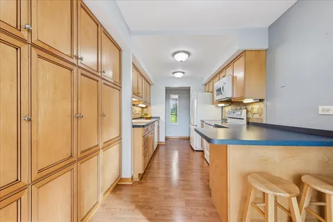 a kitchen with stainless steel appliances granite countertop counter space and a window