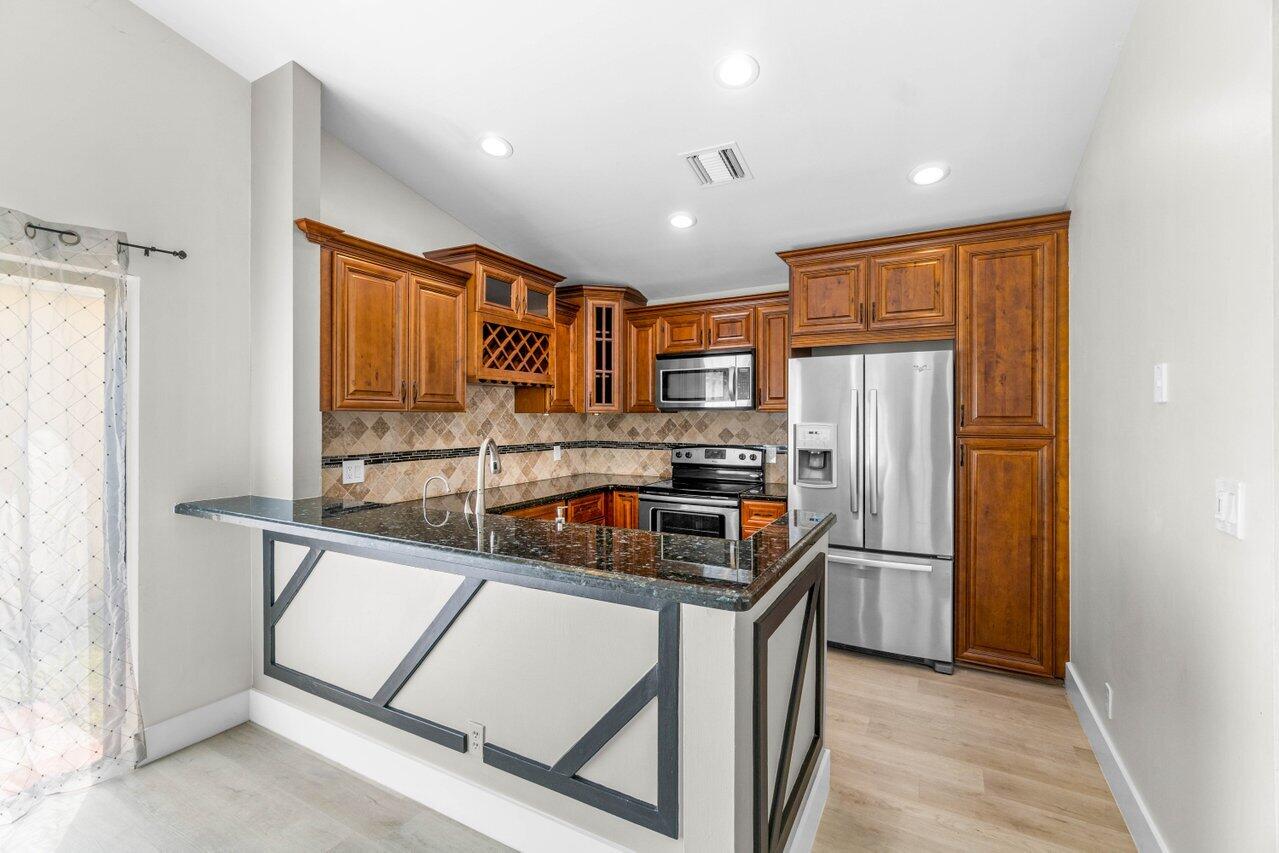 21488 Summertrace Circle Boca Raton, FL 33428 - Photo 8 of 29 a kitchen with stainless steel appliances granite countertop a refrigerator and a sink