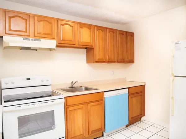 a kitchen with stainless steel appliances granite countertop a sink stove and cabinets
