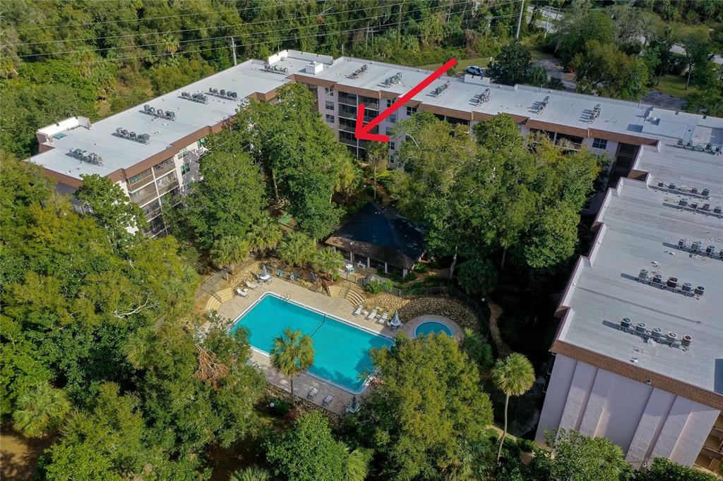 an aerial view of a house with a yard and garden
