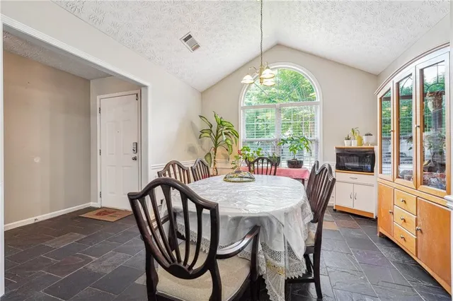 a view of a dining room with furniture window and outside view