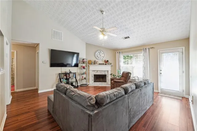 a living room with furniture a flat screen tv and a fireplace