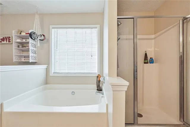 a bathroom with a bathtub next to a window