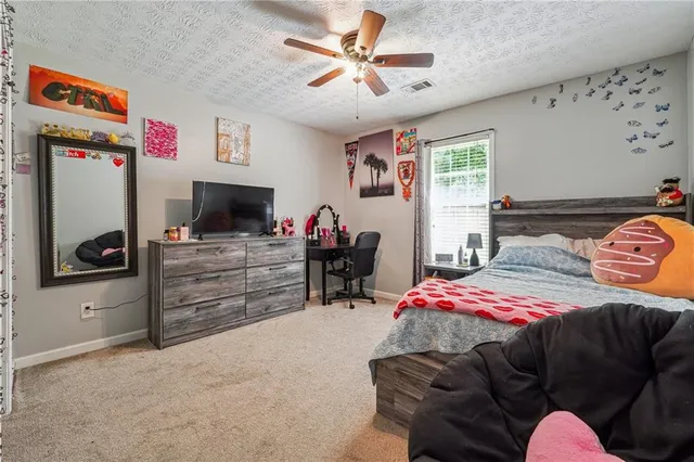 a bedroom with furniture and a flat screen tv
