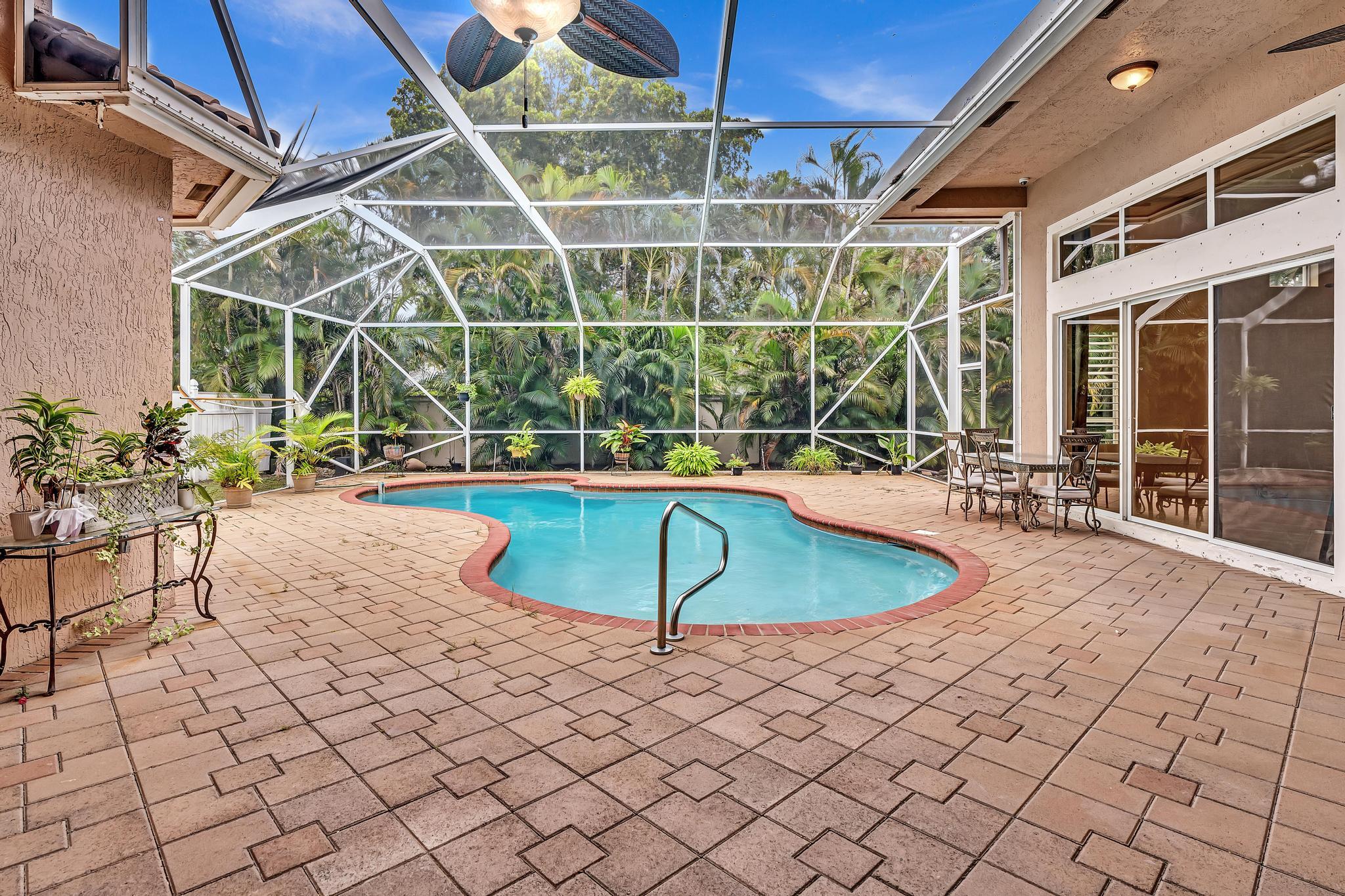 11604 Kensington Court Boca Raton, FL 33428 - Photo 18 of 81 a view of a swimming pool with a patio