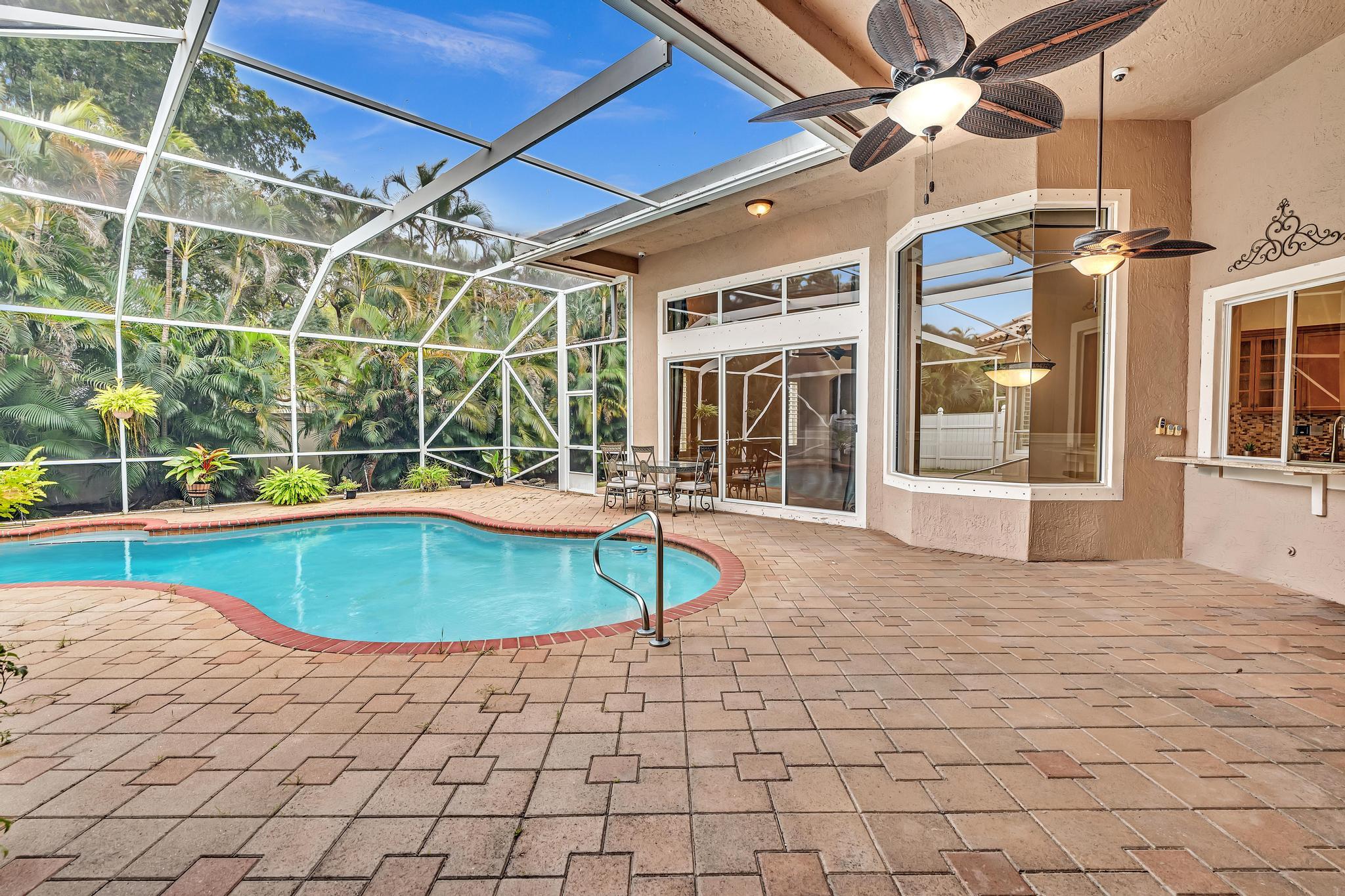 11604 Kensington Court Boca Raton, FL 33428 - Photo 25 of 81 a view of a swimming pool with a patio