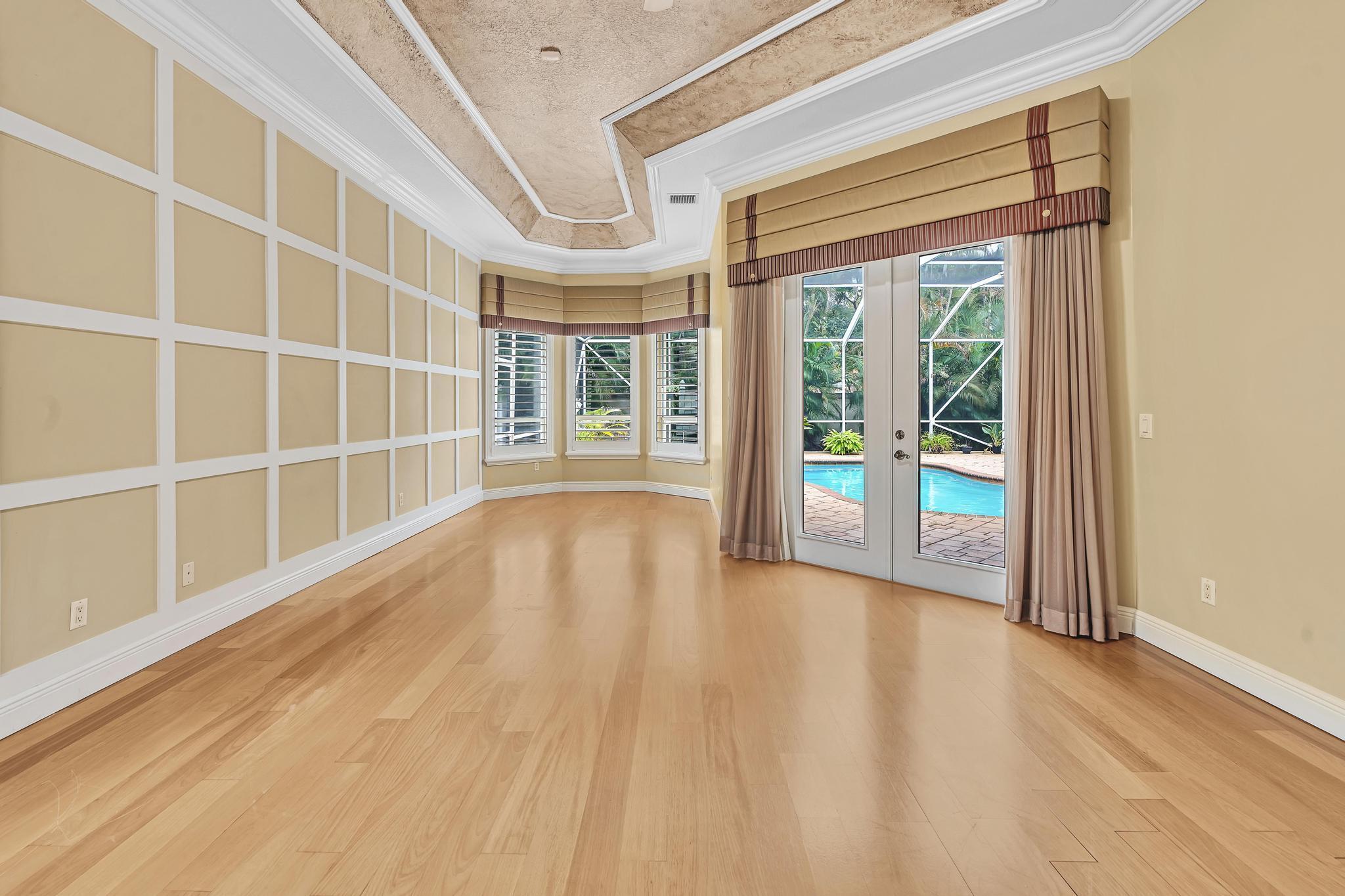 11604 Kensington Court Boca Raton, FL 33428 - Photo 28 of 81 a view of an empty room with wooden floor and a window