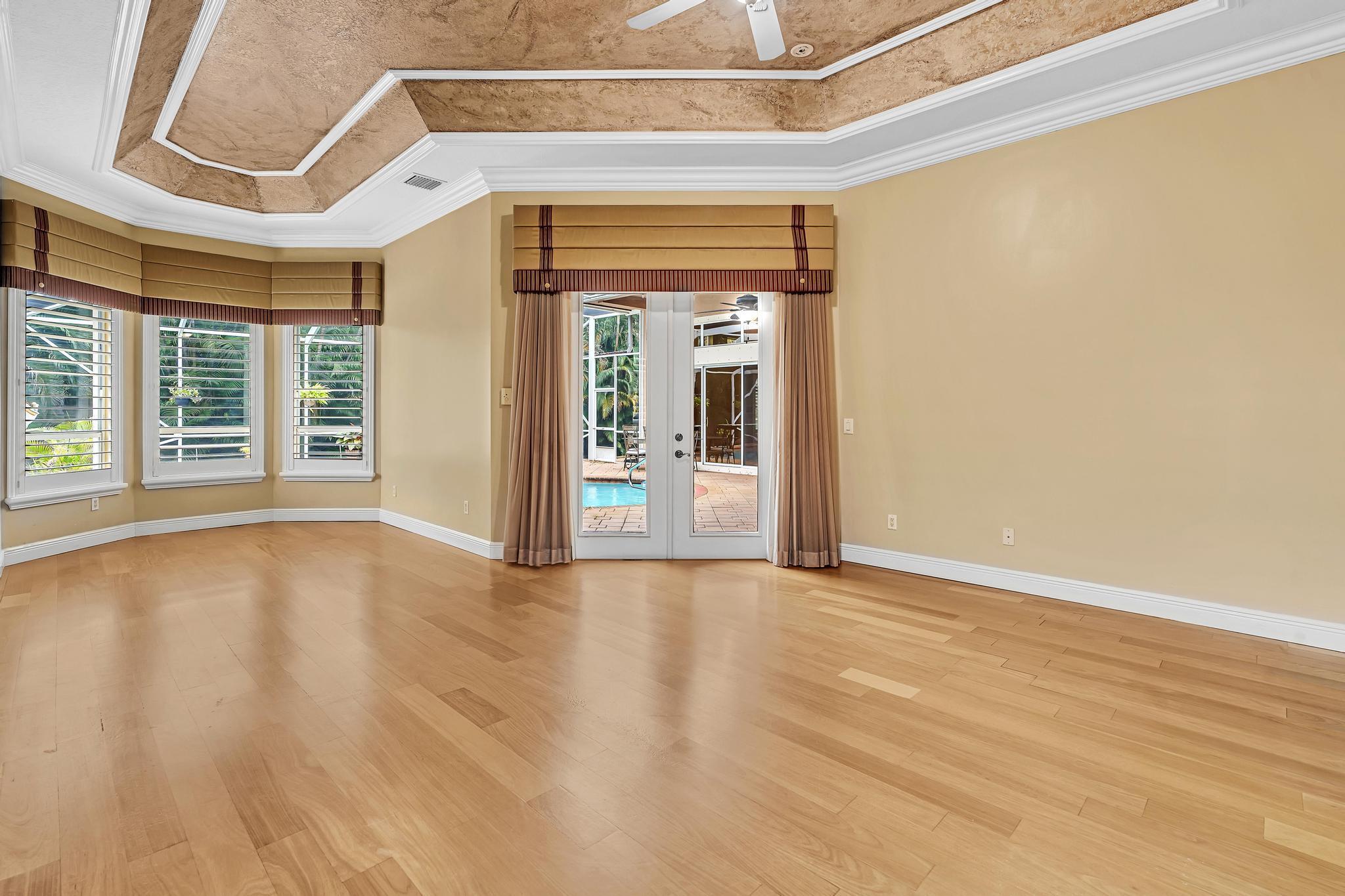 11604 Kensington Court Boca Raton, FL 33428 - Photo 29 of 81 an empty room with wooden floor and windows