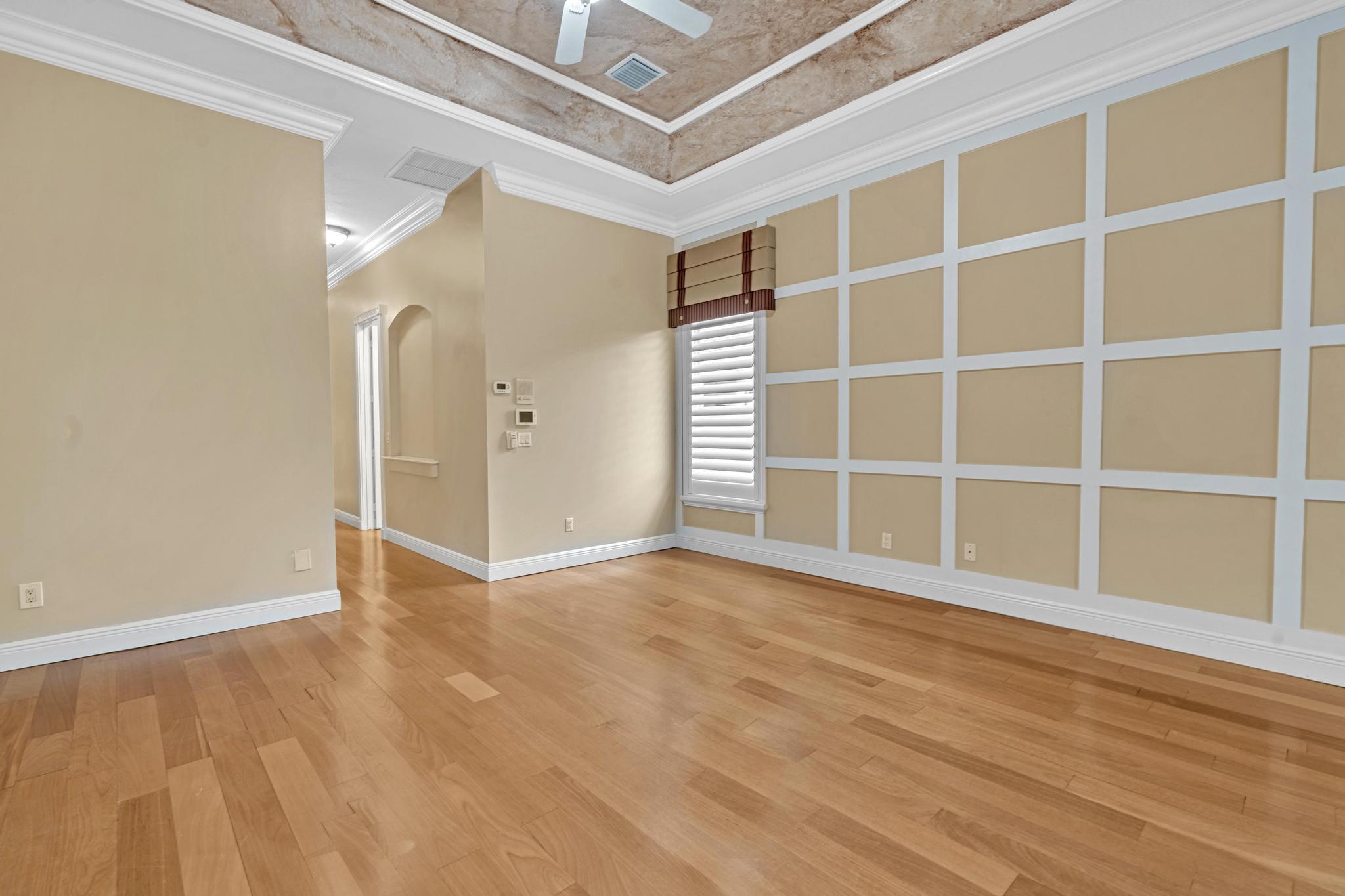 11604 Kensington Court Boca Raton, FL 33428 - Photo 32 of 81 a view of an empty room with wooden floor and a window