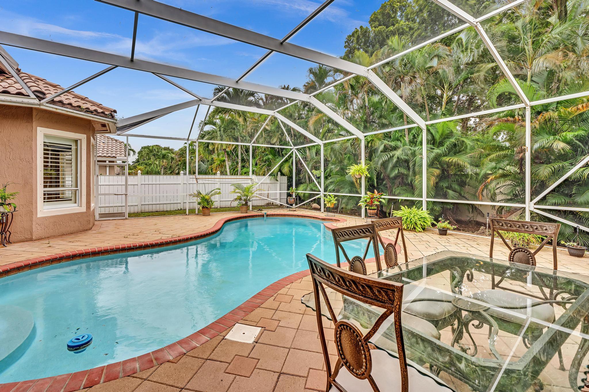 11604 Kensington Court Boca Raton, FL 33428 - Photo 52 of 81 a view of a swimming pool with a patio